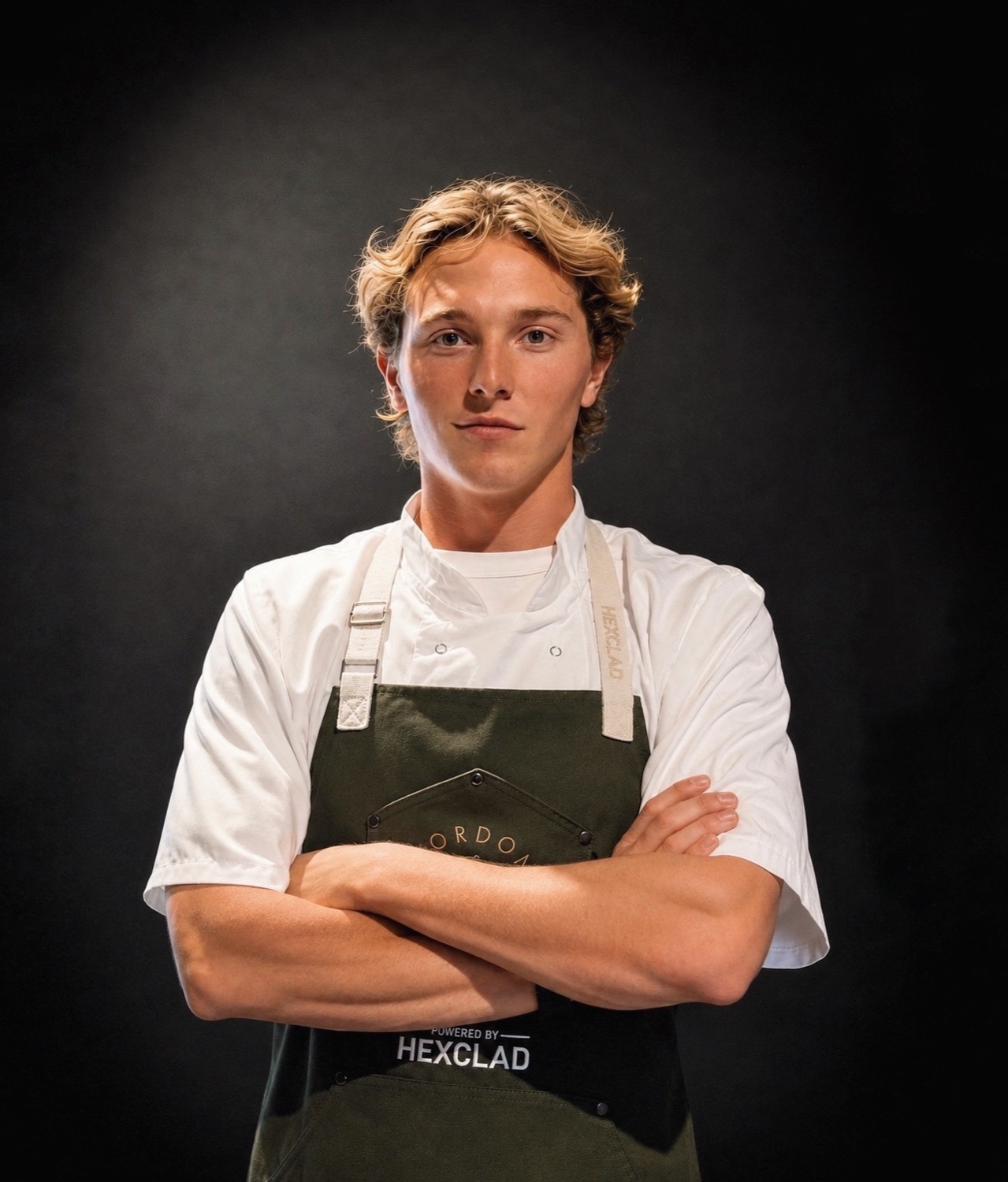 Maverick Robbins in chef whites and a Gordon Ramsay Academy apron