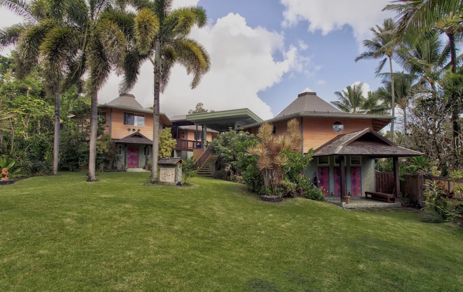 Cedar guest houses and open-air pavilion at the Pahoa retreat property