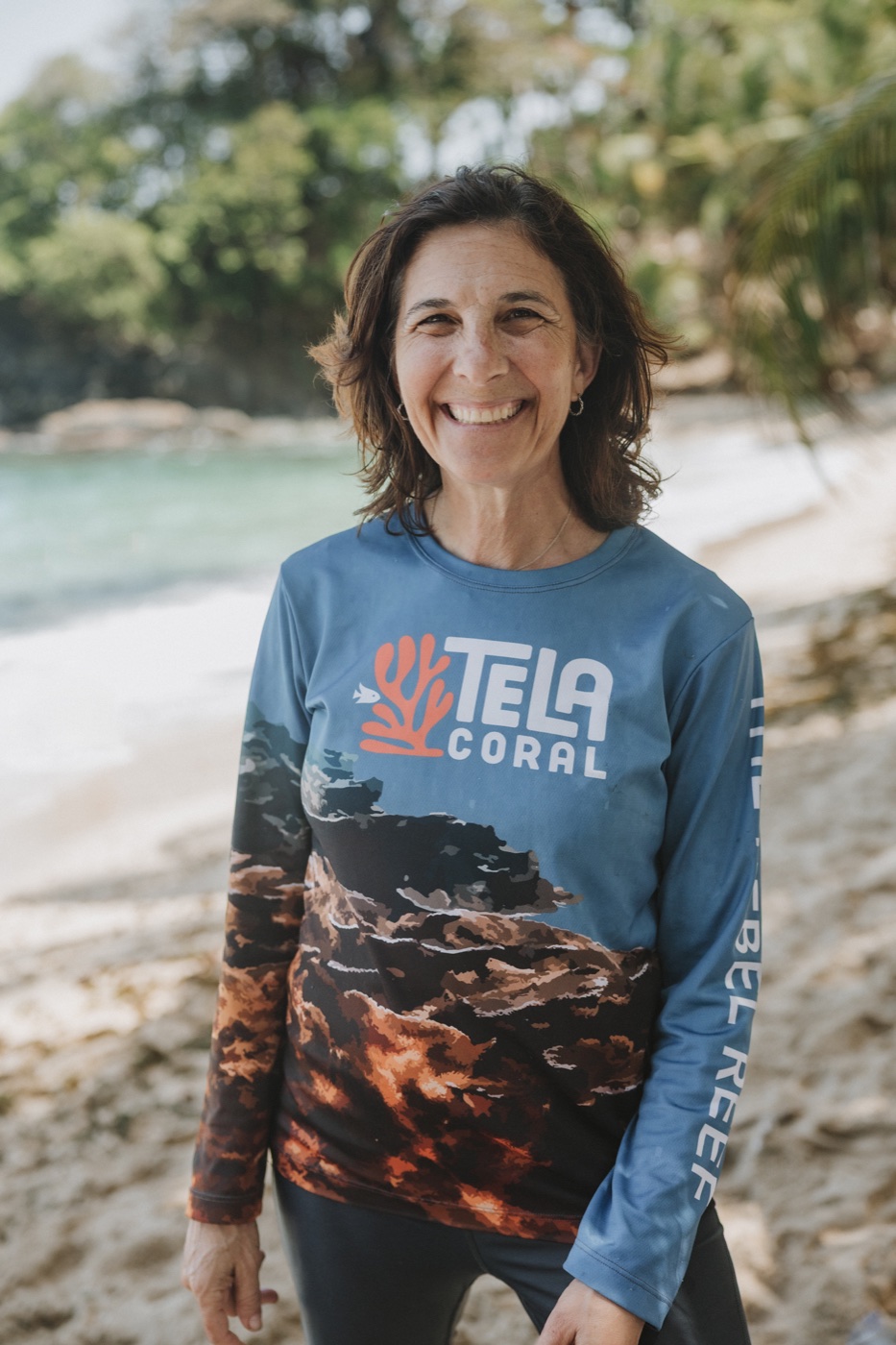 Dr. Juli Berwald on the beach at Tela, Honduras, wearing a Tela Coral rash guard