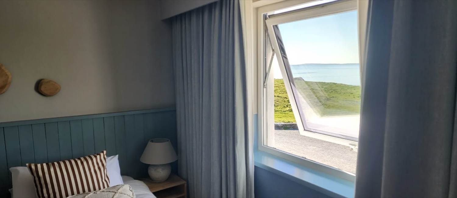 A bedroom window looking out over the sea