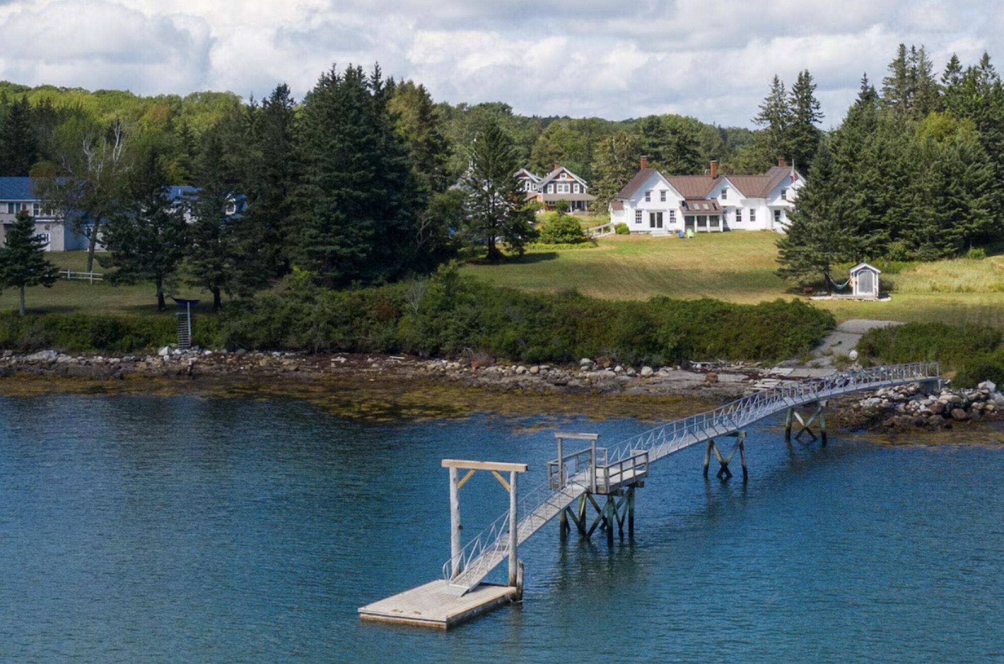 The private dock and gangway reaching out over the water below the retreat house