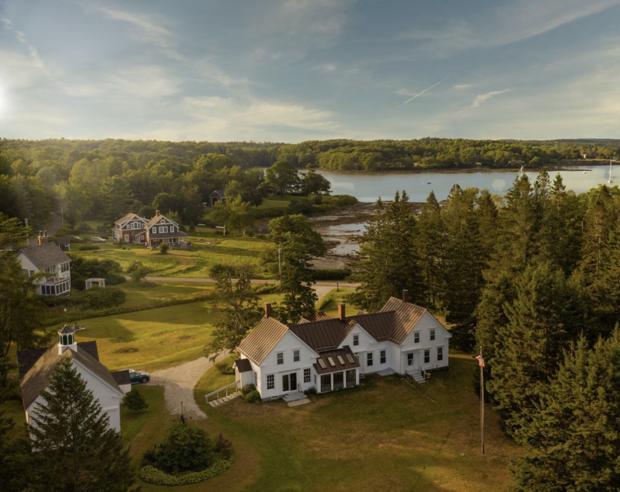 Aerial view of the retreat house and grounds running down to the shore