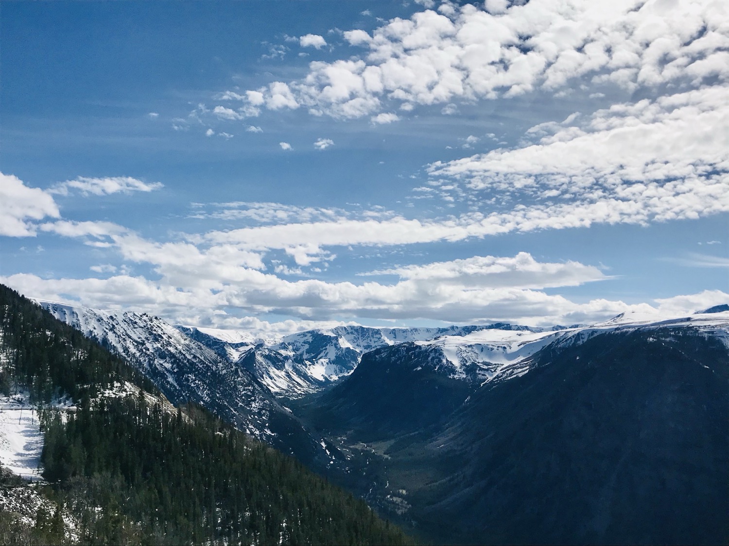 Snow-dusted peaks under big Montana sky