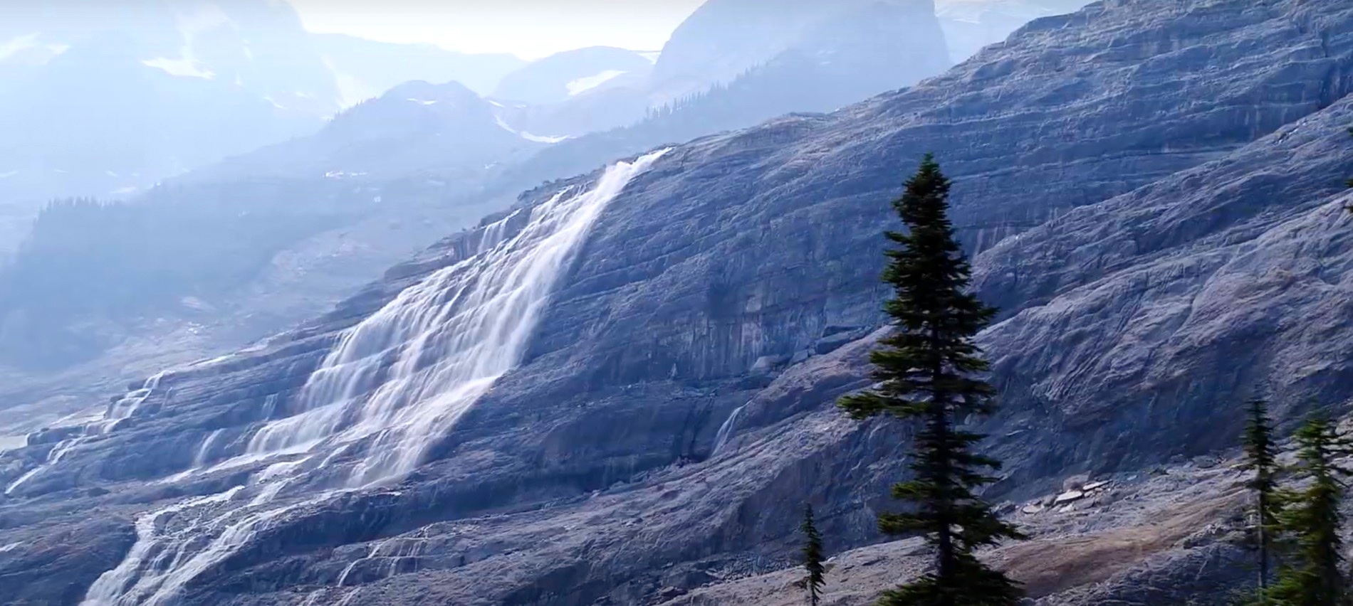 Waterfall spilling down a mountainside on the waterfall hike, Canadian Rockies