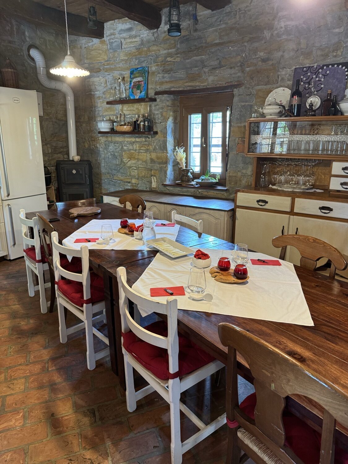 A stone-walled kitchen and dining table at our seaside stay