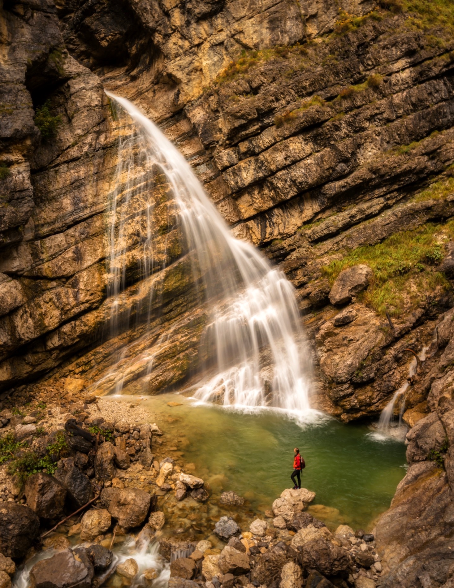 A waterfall falling into a pool in a limestone gorge, Soča Valley, Slovenia