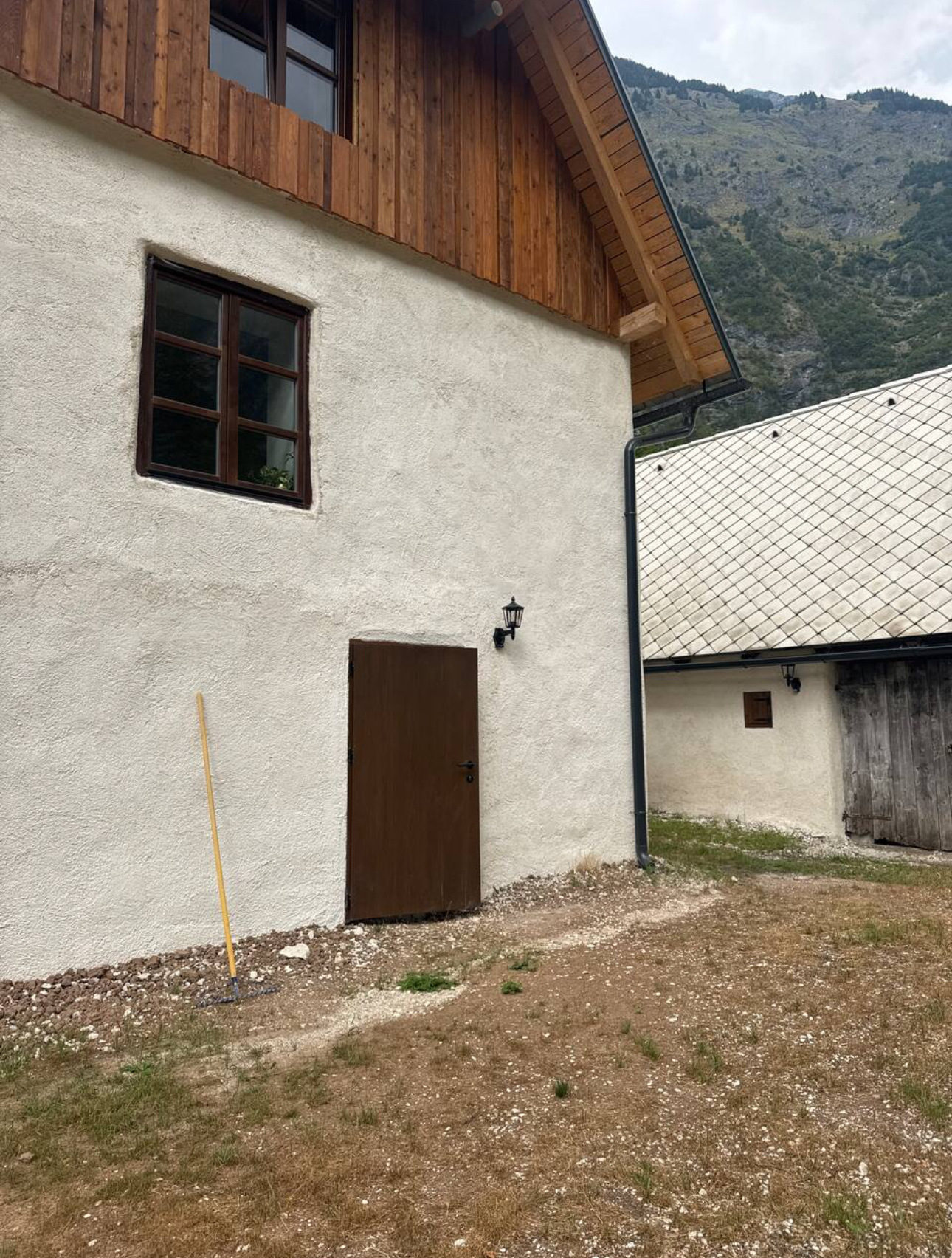 Brown door at the bottom of the Main House — entrance to the shared Guesthouse Bathroom
