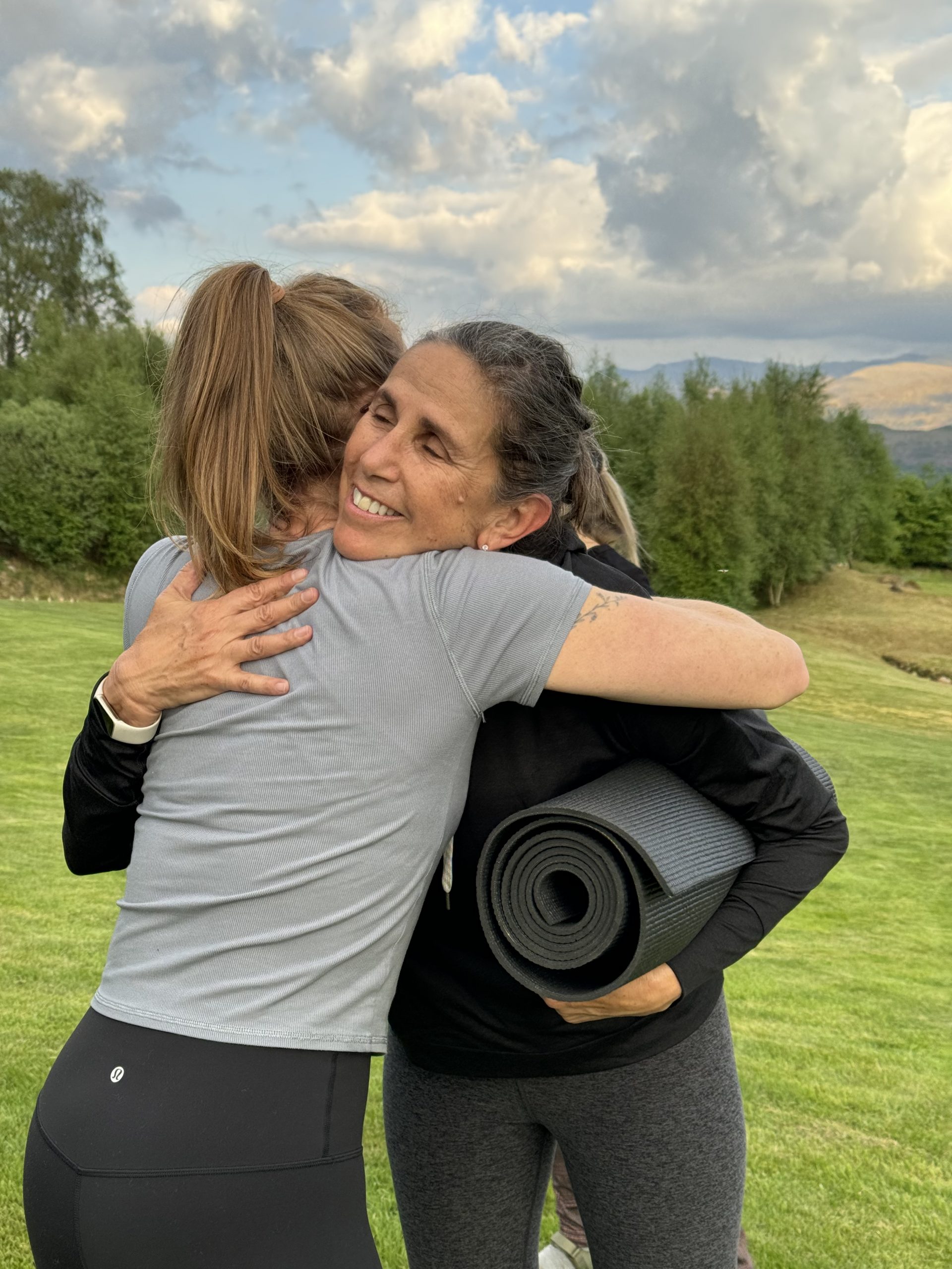 Happy retreat leader with community