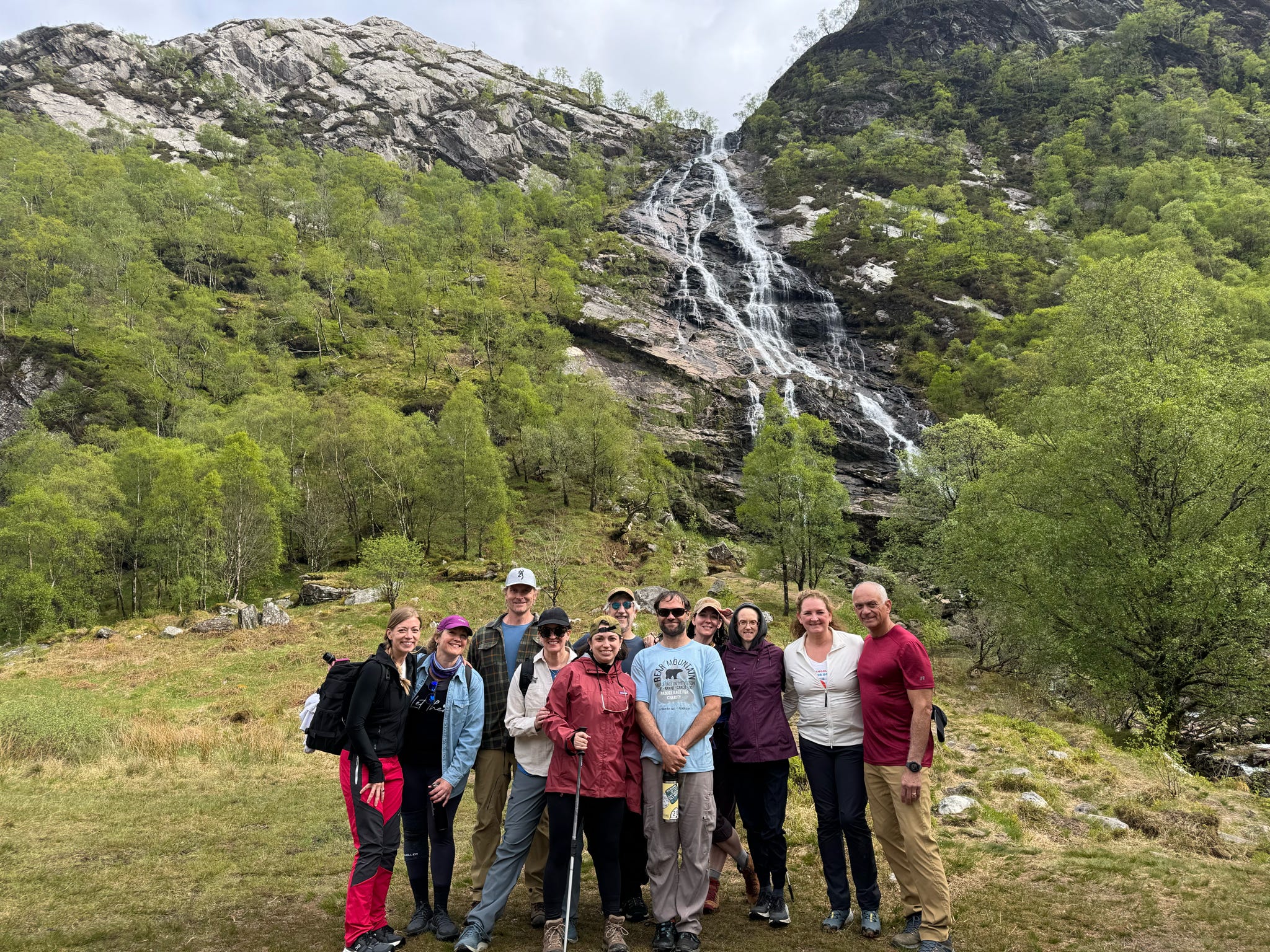 Group of travelers on guided Scotland Highland retreat hiking together