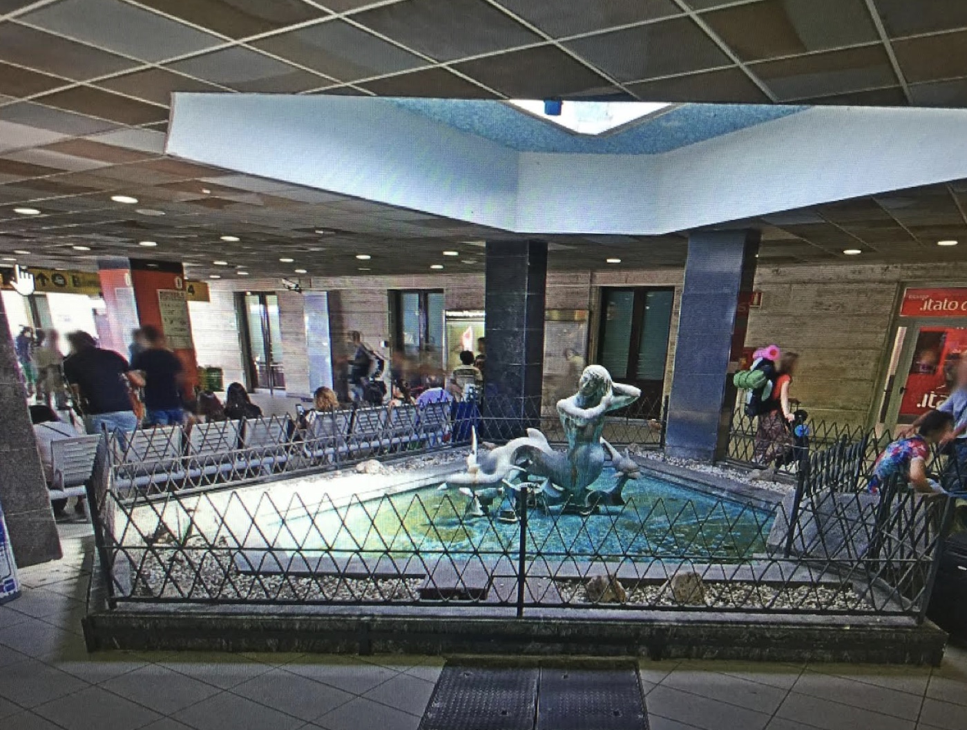 The siren fountain inside Napoli Centrale station — the meeting point for your driver
