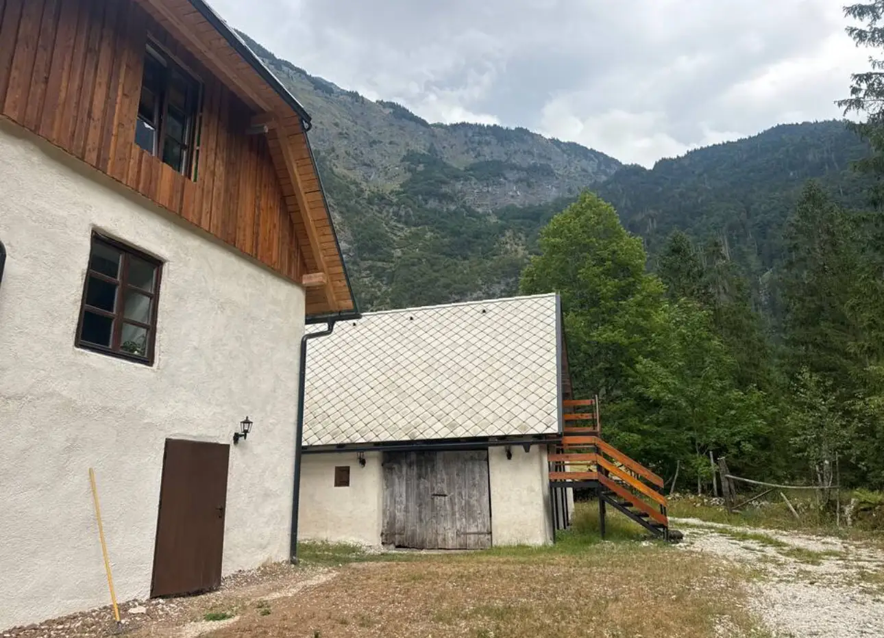 The Šunik barn room — wooden stairs on the side of the barn, next to the Guesthouse